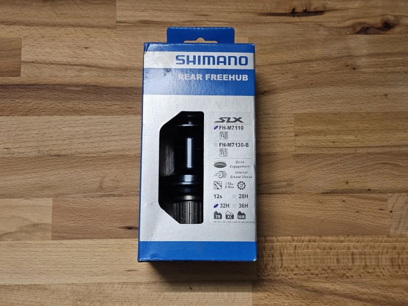 Zadní náboj Shimano SLX FH-M7110, 32 děr, 12x142 mm pro microspline; nefunkční ořech!
